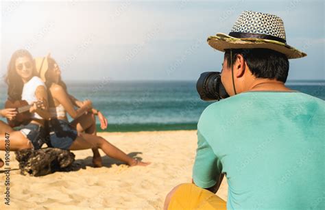 Photographers Are Photographing A Lesbian Couple In The Honeymoon With Blur Beach Background On