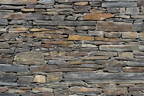 Natural free-form slate retaining wall | Slate wall, Brick effect ...