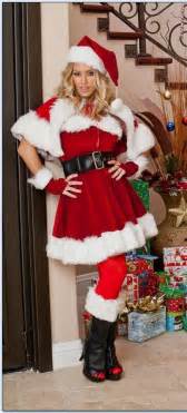 A Woman Dressed As Santa Clause Posing For A Photo