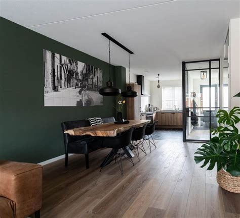 A Living Room Filled With Furniture And A Plant Next To A Doorway That