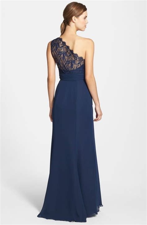 A Woman In A Long Blue Dress With An Open Back And Lace On The Top