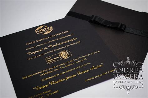 A Black And Gold Wedding Card With A Bow On It S Side Sitting Next To