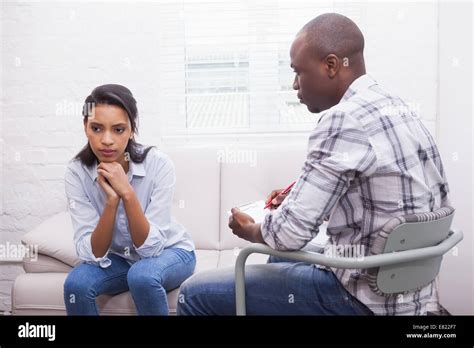 Serious therapist listening to his talking patient Stock Photo - Alamy