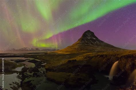 Northern lights night view over Kirkjufell volcano with fully of star ...