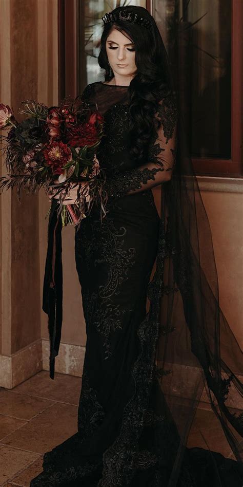 A Woman In A Black Dress Is Holding A Bouquet And Posing For The Camera