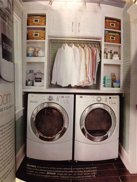 Built In Cabinets Above The Washer And Dryer With Baskets Canisters