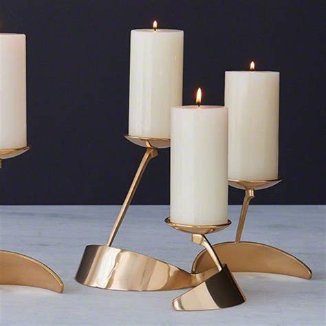 Three White Candles Sitting On Top Of Each Other