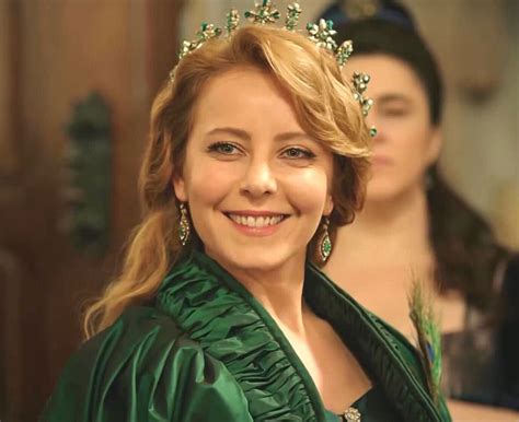 A Woman Wearing A Tiara And Smiling At The Camera With Other Women