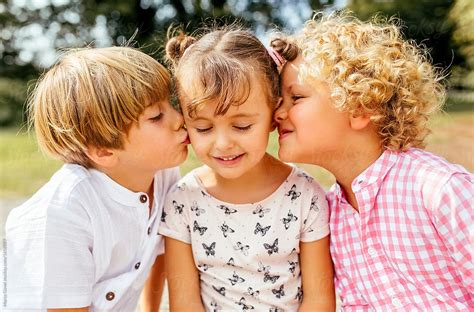 Two Kids Giving A Little Kiss To Their Best Friend By Stocksy