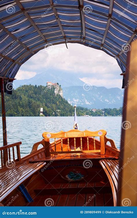 Wooden Tourist Boat On Lake Bled In Slovenia With The Bled Castle On