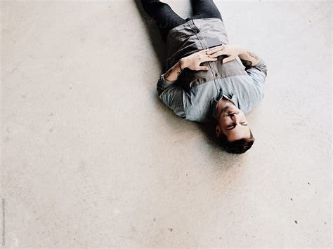 "Man Laying Upside Down" by Stocksy Contributor "Carey Shaw" - Stocksy