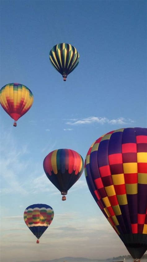 several hot air balloons flying in the sky