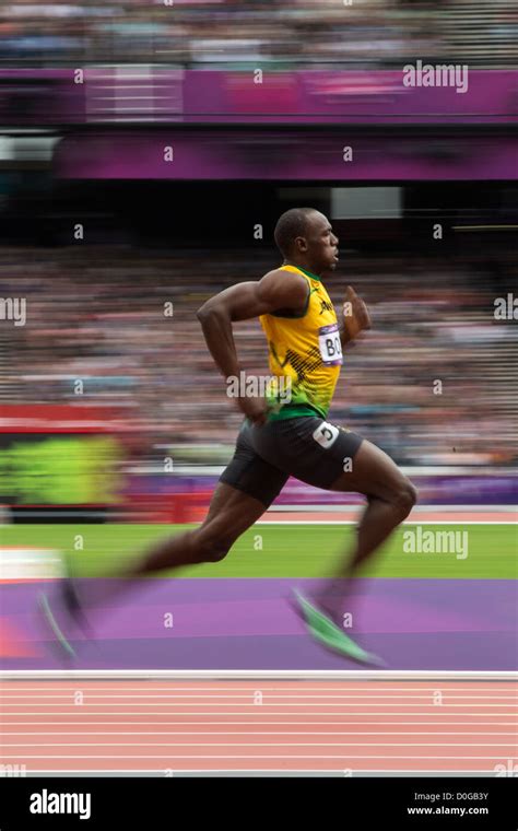 Blurred action of Usain Bolt (JAM) competing in the Men's 100m 1st round at the Olympic Summer ...