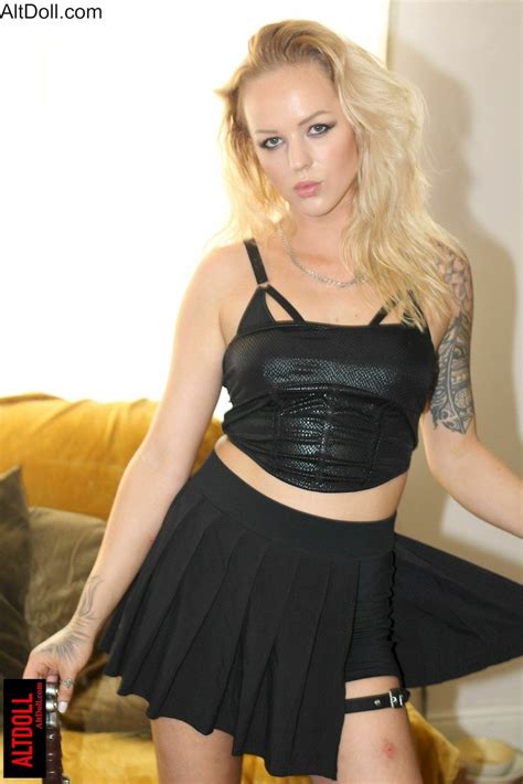 Tattooed Blonde Girl Showing Off Her Sword In A Black Outfit Photos