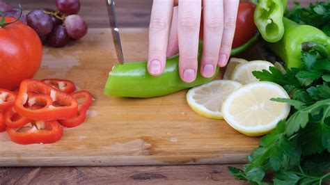 person cutting green pepper 23358927 Stock Video at Vecteezy