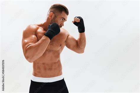 Man Athletic Bodybuilder Poses In Boxing Gloves With Nude Torso Abs In