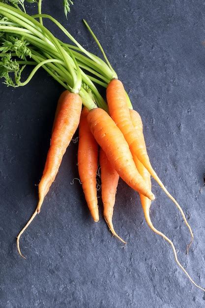 Premium Photo Small Baby Carrot With Green Leafs