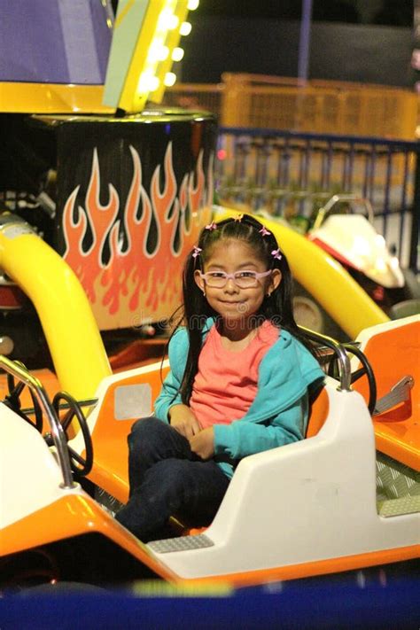 Year Old Brunette Girl With Glasses Has Fun On An Amusement Park Ride Spending Her Summer