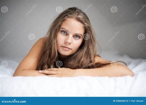 Relaxed And Naturally Beautiful Portrait Of A Beautiful Woman Lying In