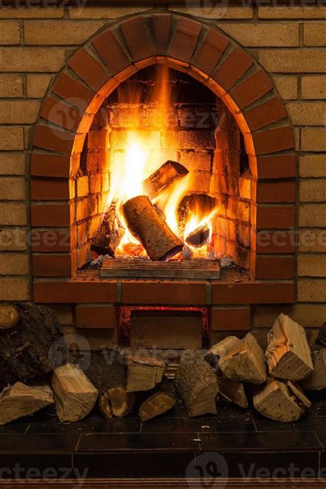 wooden logs and fire in fireplace 12912902 Stock Photo at Vecteezy