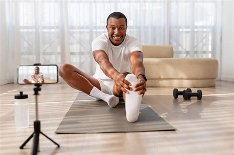 Premium Photo Man Stretching On Yoga Mat During Workout