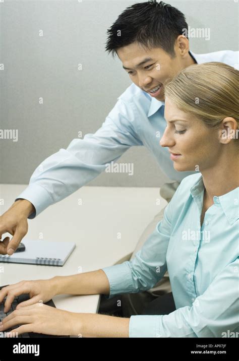 Man Helping Female Colleague Stock Photo Alamy