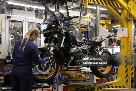 A Female Trainee Works On The Assembly Line At The Bmw Motorcycle