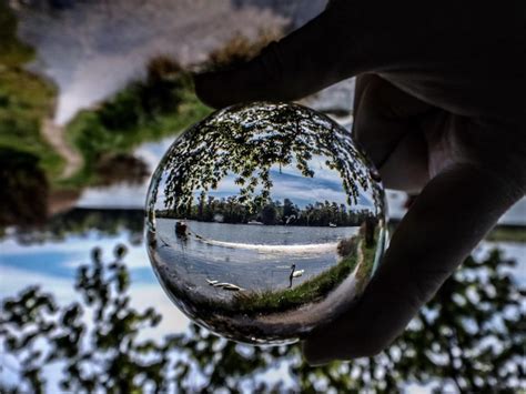 Premium Photo Cropped Hand Of Person Holding Crystal Ball With Reflection