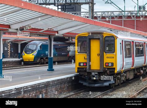 Avanti West Coast Pendolino Train At Crewe Railway Station With A Transport For Wales Local