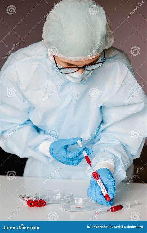 Microbiologist Testing A Tube With Biological Sample Syringe With