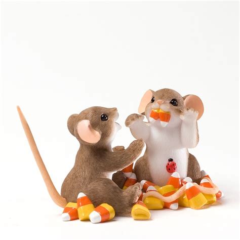 Two Toy Mice Sitting On Top Of Candy Corn And One Holding A Carrot In