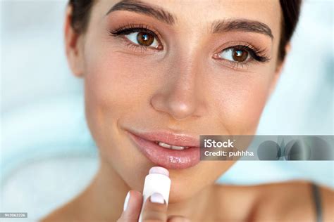 Beautiful Woman With Beauty Face Applies Balm On Lips Skin Care Stock