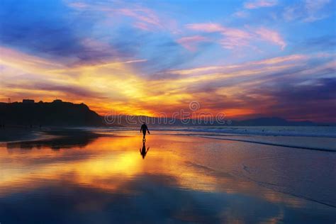 Man Walking On The Beach At Sunset Stock Image - Image: 62542849