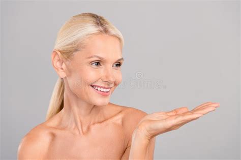 Photo Of Smiling Happy Retired Lady Naked Shoulders Perfect Facial Skin Hold Empty Space Open
