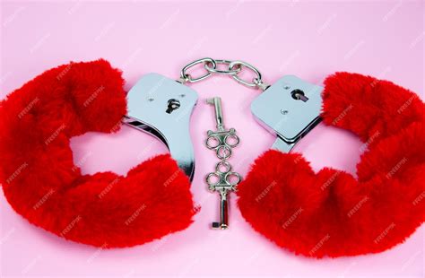 Premium Photo Red Sexy Fluffy Handcuffs With Keys On A Pink Background