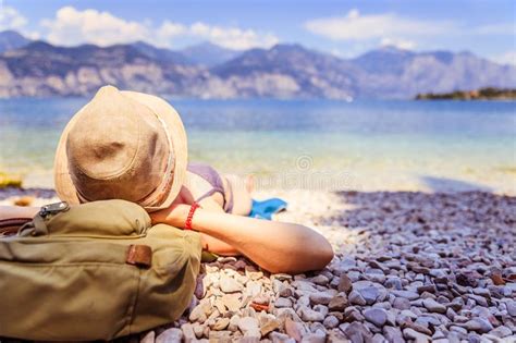 La Belle Jeune Fille Avec Le Chapeau De Paille Dans Le Bikini Se Trouve Sur Le Pebble Beach Et