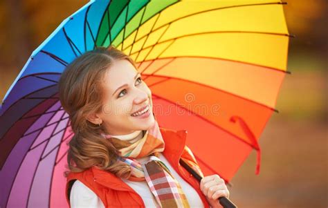 Happy Woman With Rainbow Multicolored Umbrella Under Rain In Par Stock