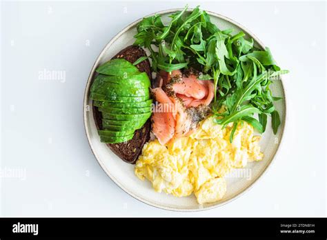 Keto Breakfast Avocado Toast Smoked Salmon Scrambled Eggs And Arugula White Background Top