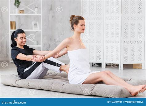 Young Woman Getting Traditional Thai Stretching Massage By Therapist