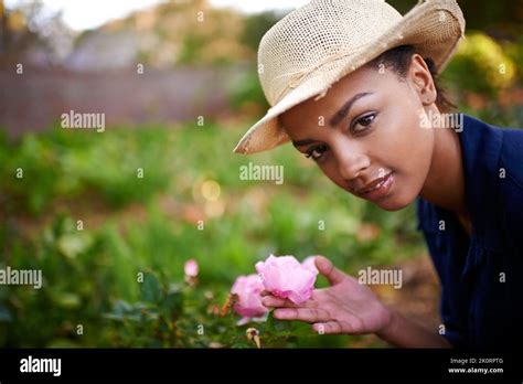 Shes A Natural Gardener Portrait Of A Young Woman Admiring The Roses