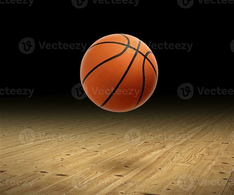 A basketball with a dark background on a hardwood gym floor 25851989 ...