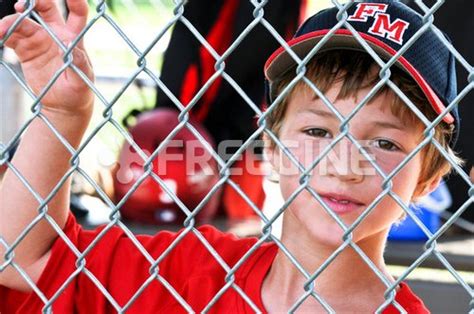 유토이미지 Youth baseball player in dugout