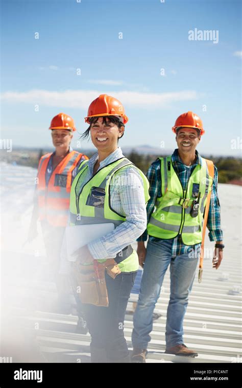 Portrait Smiling Confident Engineers At Sunny Power Plant Stock Photo