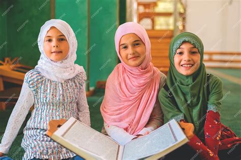 Premium Photo A Group Of Children Reads The Quran In The Mosque