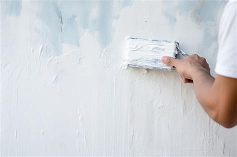 Premium Photo Close Up Of Hand Painting Wall With Roller