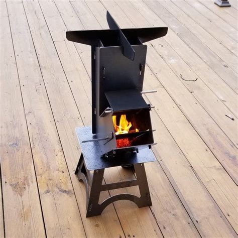 An Outdoor Stove On A Wooden Deck With Fire Burning In It S Burner