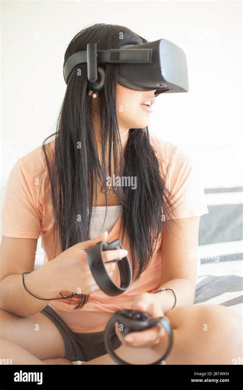 Young Asian Woman Wearing Virtual Reality Headset Oculus Rift And