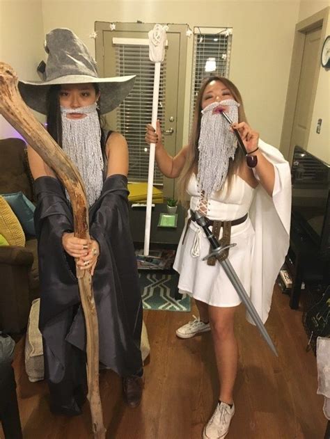 Two People Dressed Up As Wizard And Witch With Long White Beards