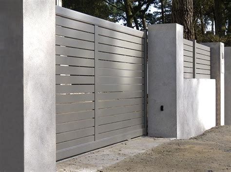 The Gate Is Made Of Concrete And Has Metal Bars On Each Side Along