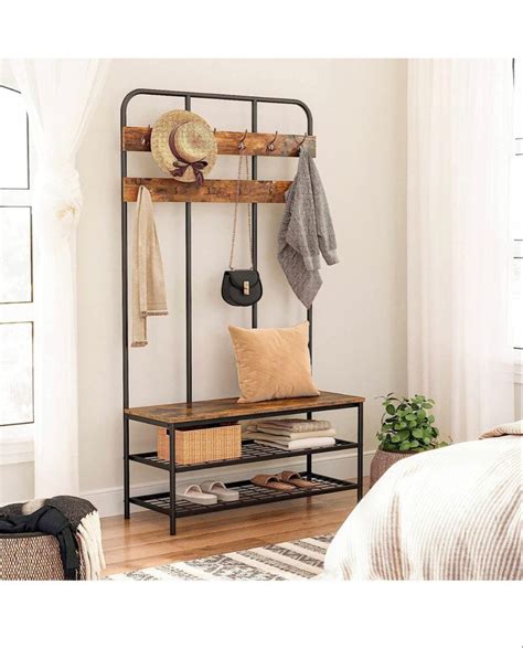 A Coat Rack With Shoes And Hats Hanging From It S Sides Next To A Bed